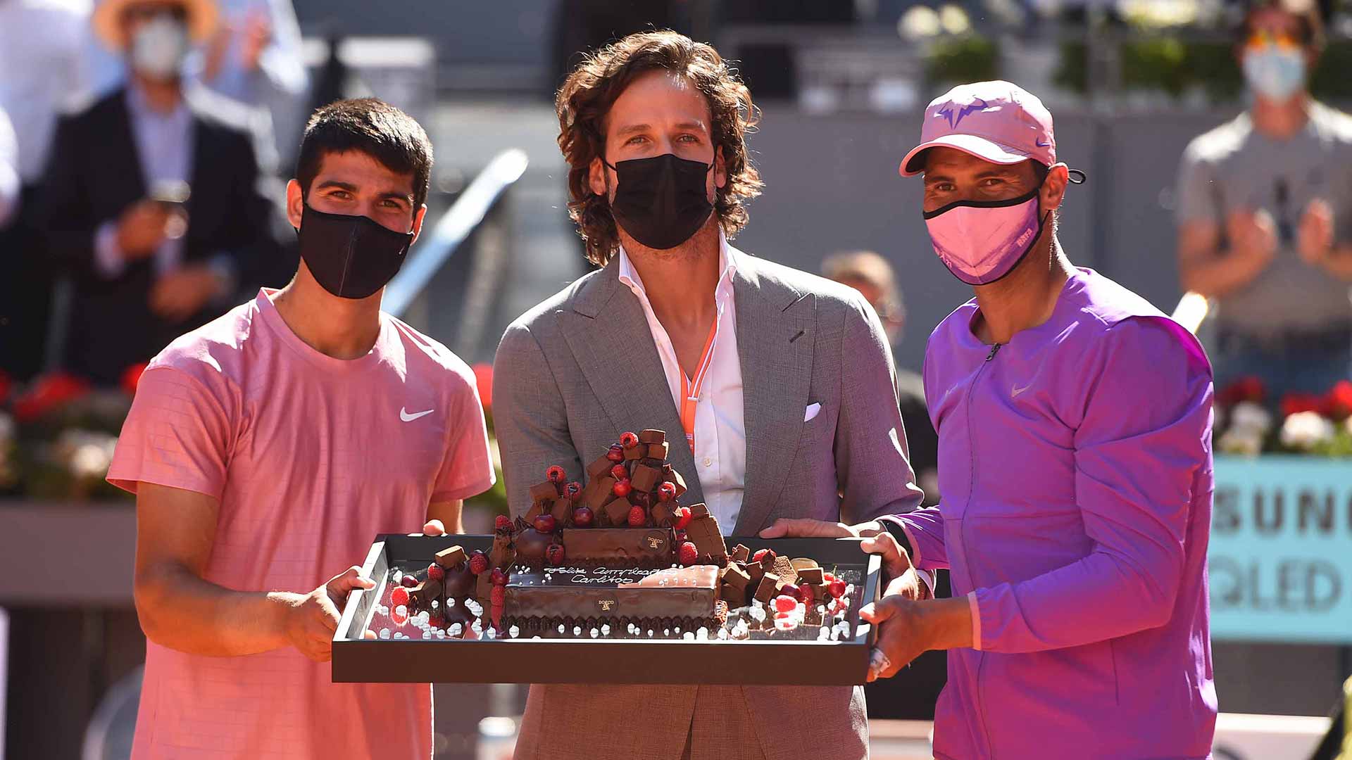Carlos Alcaraz receives an 18th birthday cake after his match with Rafael Nadal from Madrid TD Feliciano Lopez.
