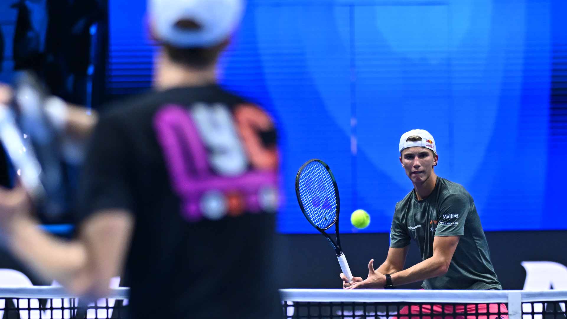 Jannik Sinner and Nicolai Budkov Kjaer practise in Turin.