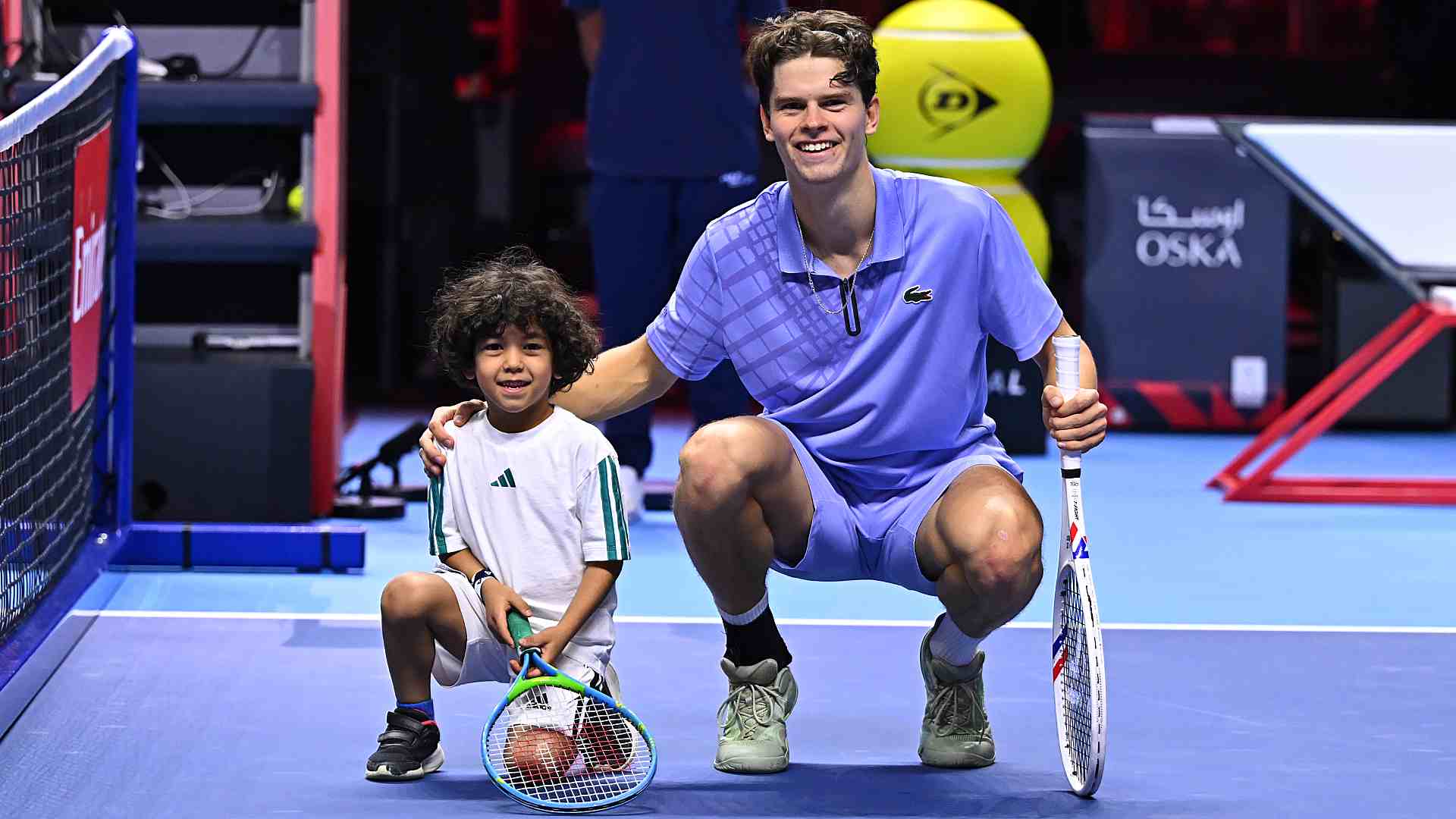 Alexander Blockx with a kid at the Next Gen ATP Finals presented by PIF.