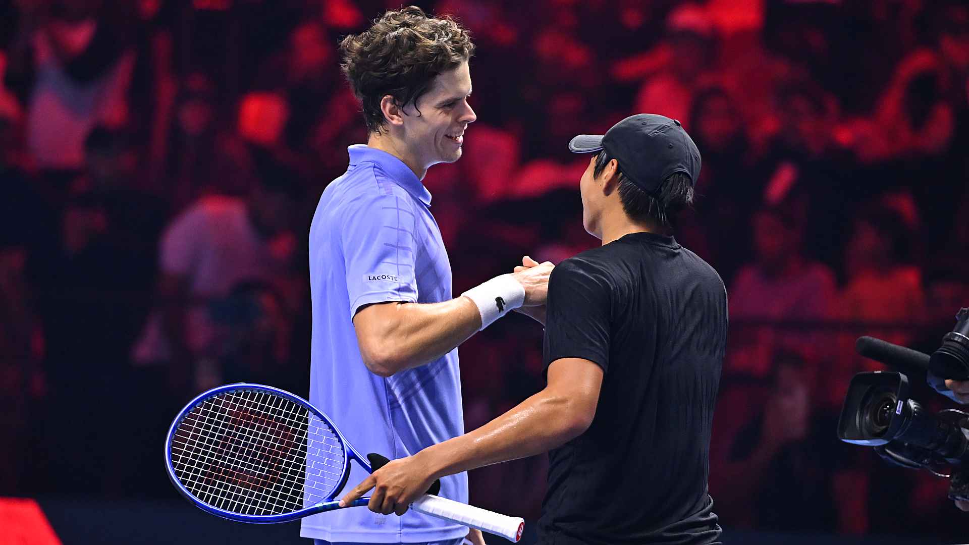 Alexander Blockx congratulates Learner Tien at the net after Tien defeated him in the final.
